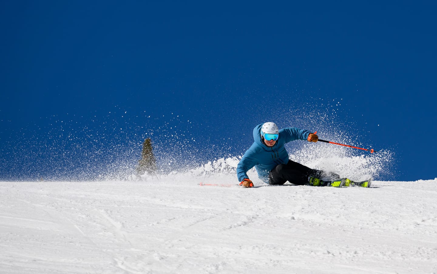 Tomas Mical carving against a deep blue sky